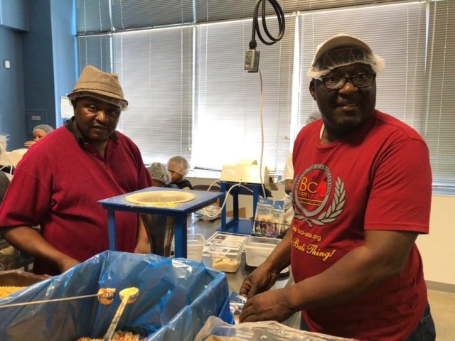 Two adult volunteers packeting