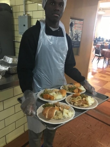 Young man wearing food protection serving for the kids