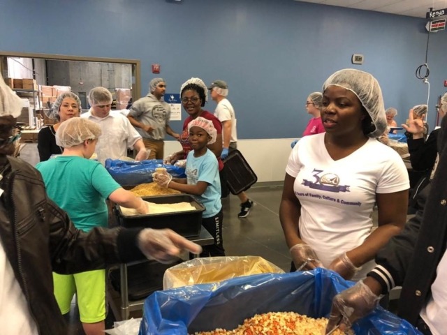 Group of volunteers packeting for food in another section