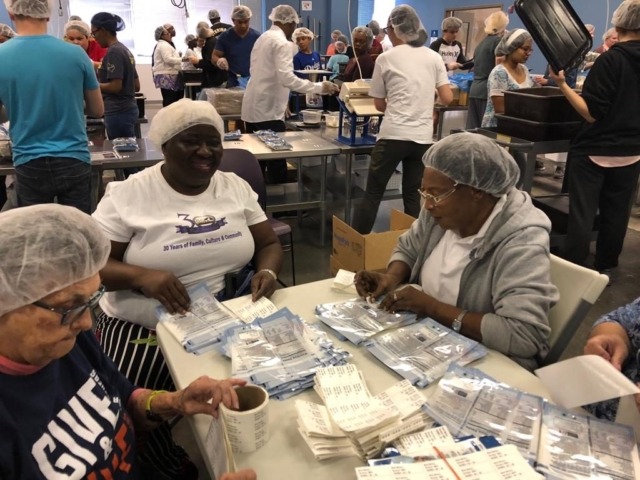Group of volunteers wrapping up supplies
