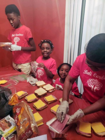 Group of volunteers making sandwiches